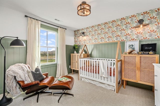 bedroom with wallpapered walls, visible vents, carpet flooring, and wainscoting