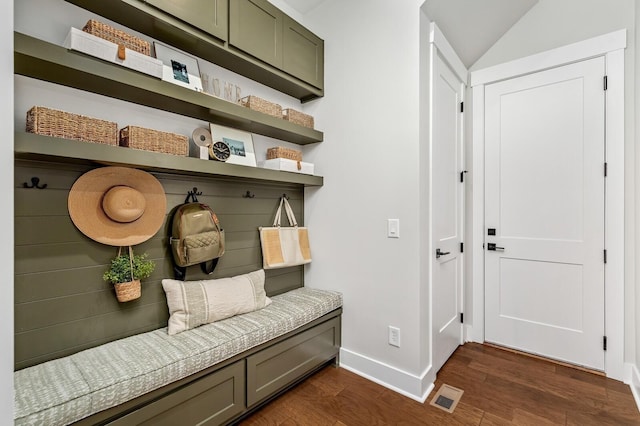 mudroom featuring lofted ceiling, baseboards, visible vents, and dark wood-style floors