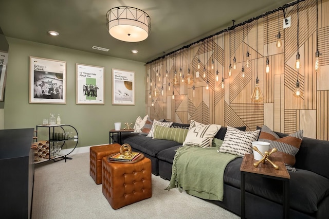 carpeted home theater room with visible vents and baseboards