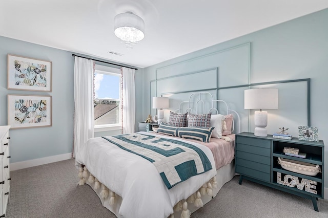 bedroom featuring light carpet, baseboards, visible vents, and a chandelier