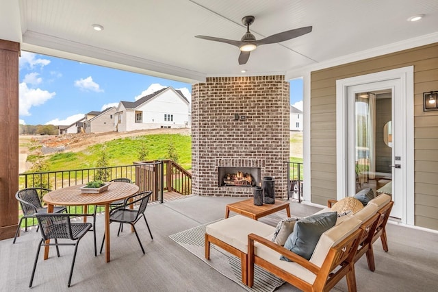 view of patio featuring an outdoor living space with a fireplace and a ceiling fan