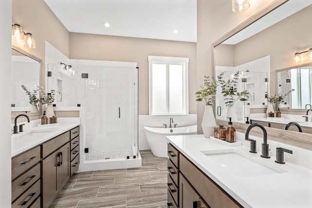 full bath with a soaking tub, a sink, and a stall shower