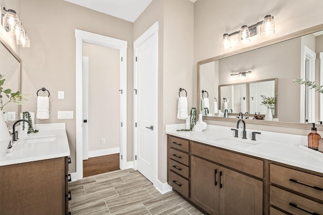 bathroom with baseboards and vanity