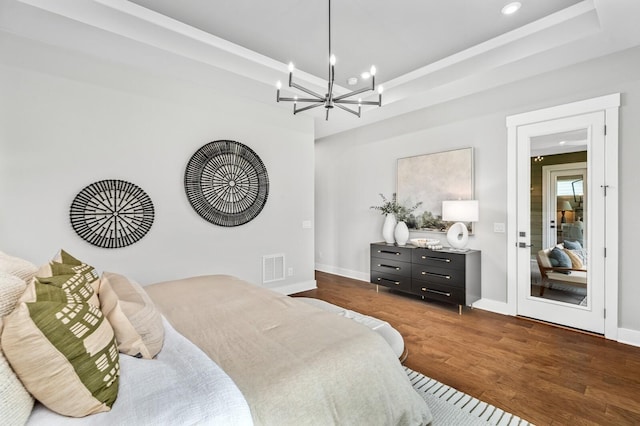bedroom with baseboards, visible vents, recessed lighting, a chandelier, and wood finished floors