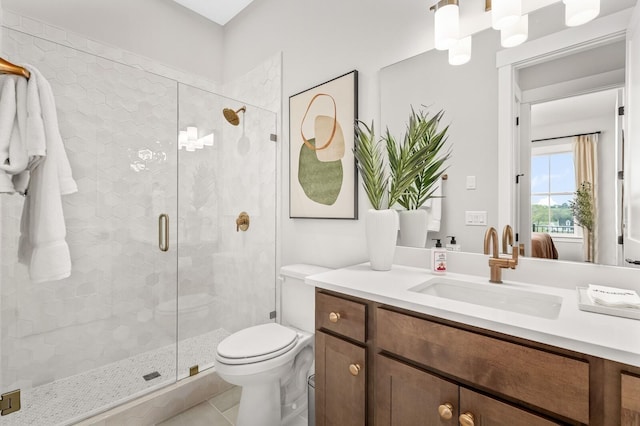 ensuite bathroom with a shower stall, toilet, vanity, and connected bathroom