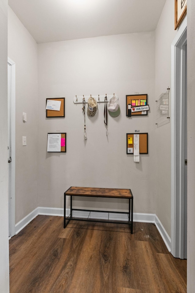 hallway with wood finished floors and baseboards