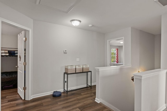 hall featuring an upstairs landing, baseboards, dark wood-type flooring, and visible vents