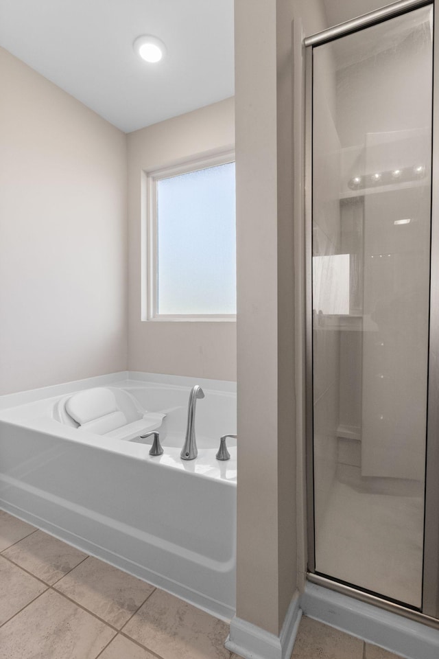 full bath with a shower stall, a garden tub, and tile patterned flooring