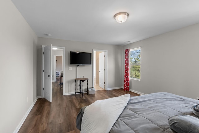 bedroom with baseboards and wood finished floors