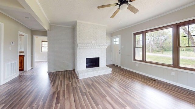 unfurnished living room with wood finished floors, a ceiling fan, visible vents, and ornamental molding