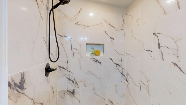 bathroom with a marble finish shower