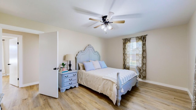 bedroom with light wood-style flooring, a ceiling fan, and baseboards