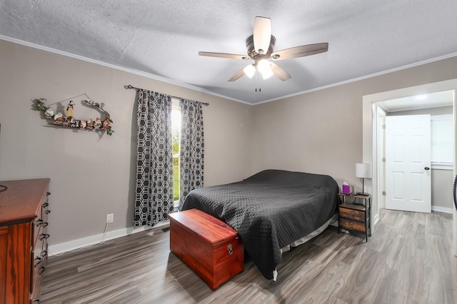 96 Concord Cades Rd, Milan, TN 38358 - bedroom with baseboards, wood finished floors, a textured ceiling, and crown molding