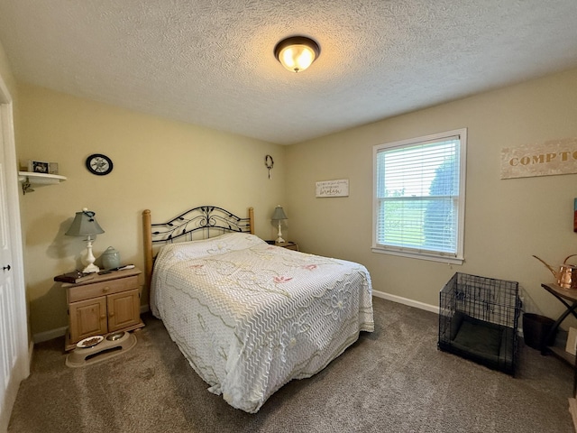 bedroom featuring baseboards, dark colored carpet, and a textured ceiling