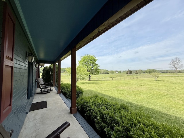 view of yard with a rural view and fence