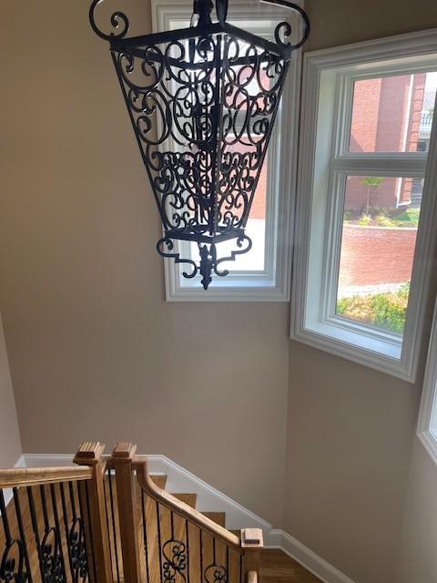 889 Plantation Blvd, Gallatin, TN 37066 - stairs with a healthy amount of sunlight, baseboards, and an inviting chandelier