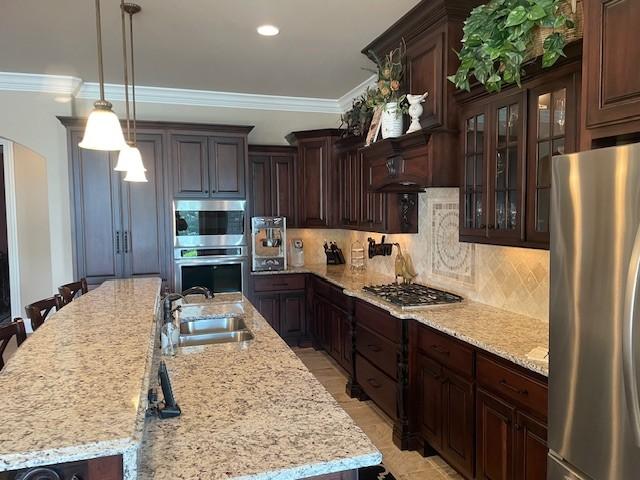 889 Plantation Blvd, Gallatin, TN 37066 - kitchen featuring stainless steel appliances, dark brown cabinets, ornamental molding, a sink, and decorative backsplash