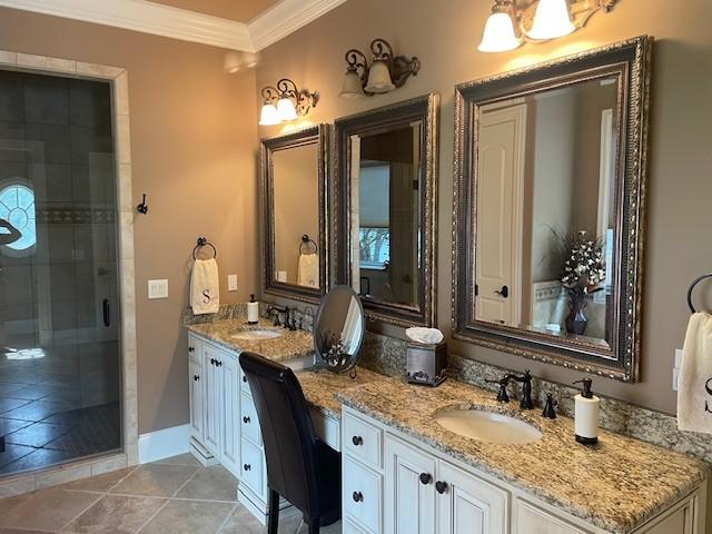 889 Plantation Blvd, Gallatin, TN 37066 - full bathroom featuring a shower stall, a sink, double vanity, ornamental molding, and tile patterned flooring