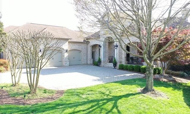 889 Plantation Blvd, Gallatin, TN 37066 - view of front facade with driveway, a front lawn, and a garage