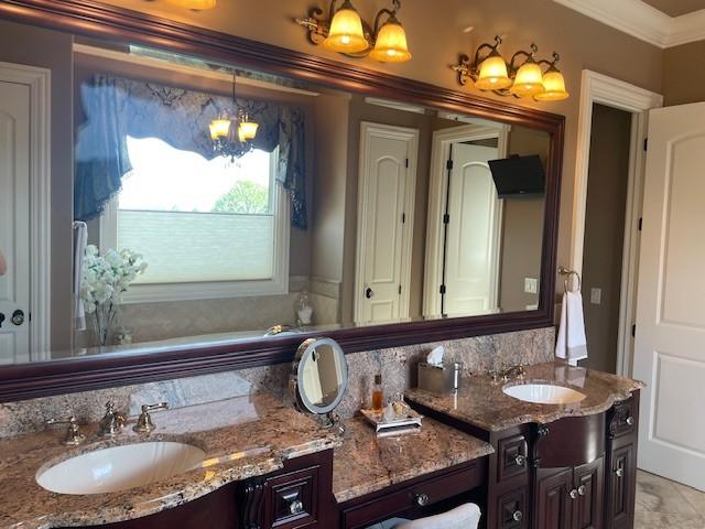 889 Plantation Blvd, Gallatin, TN 37066 - full bath featuring vanity, ornamental molding, and an inviting chandelier