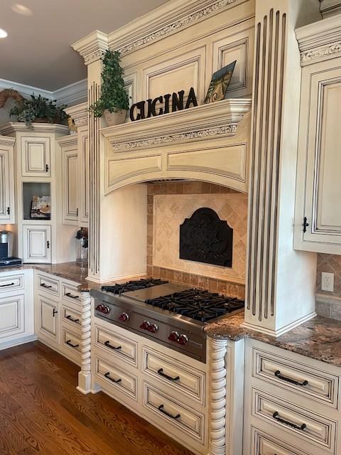 889 Plantation Blvd, Gallatin, TN 37066 - kitchen featuring cream cabinets, decorative backsplash, stainless steel gas cooktop, and dark stone countertops