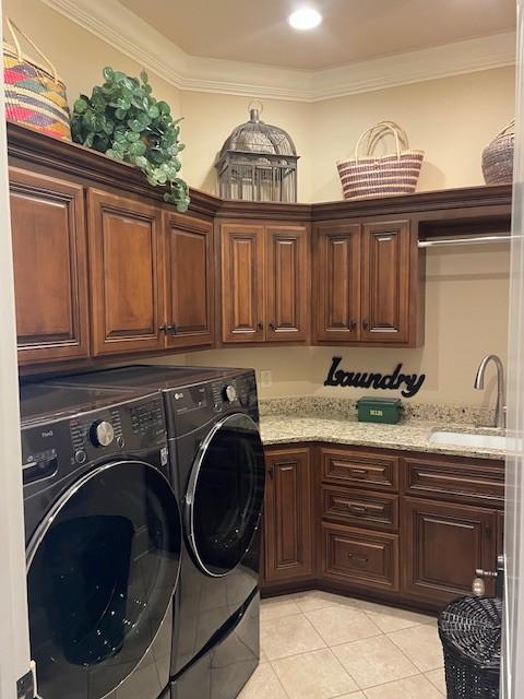 889 Plantation Blvd, Gallatin, TN 37066 - laundry area featuring a sink, light tile patterned flooring, crown molding, washer and dryer, and cabinet space