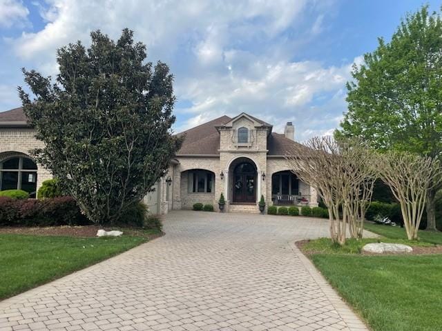 889 Plantation Blvd, Gallatin, TN 37066 - french provincial home featuring brick siding, a front yard, a chimney, and curved driveway