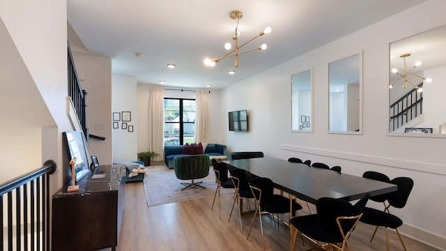 dining space featuring recessed lighting, wood finished floors, and a notable chandelier