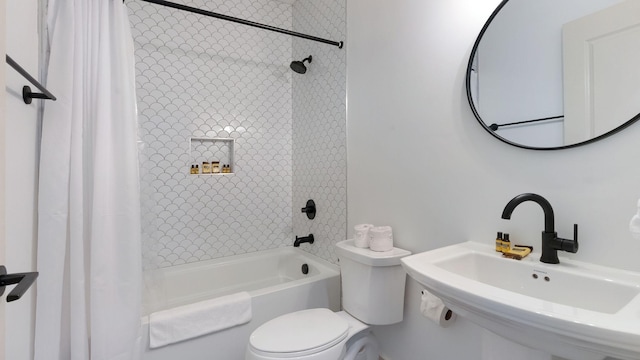 full bathroom with shower / tub combo, toilet, and a sink