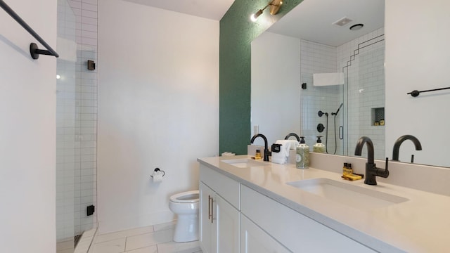 full bath featuring a sink, a shower stall, double vanity, and toilet