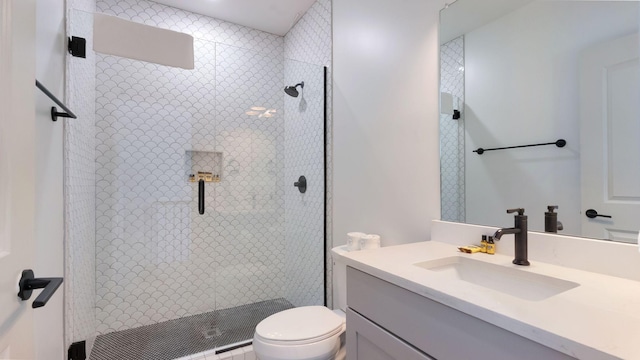 full bath featuring vanity, toilet, and a stall shower