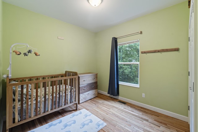 6336 Hickory Dr, Centerville, TN 37033 - bedroom with wood finished floors and a crib