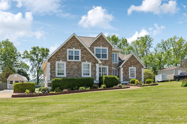 view of front facade with a front yard and stone siding