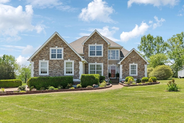 view of front of house with stone siding and a front lawn
