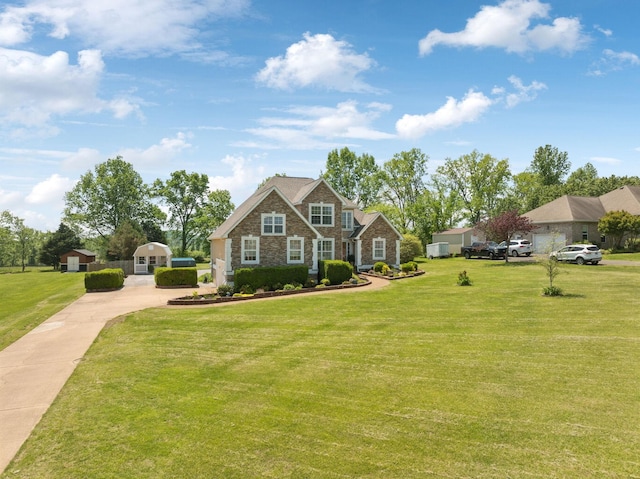 craftsman inspired home with driveway, a front lawn, and stone siding