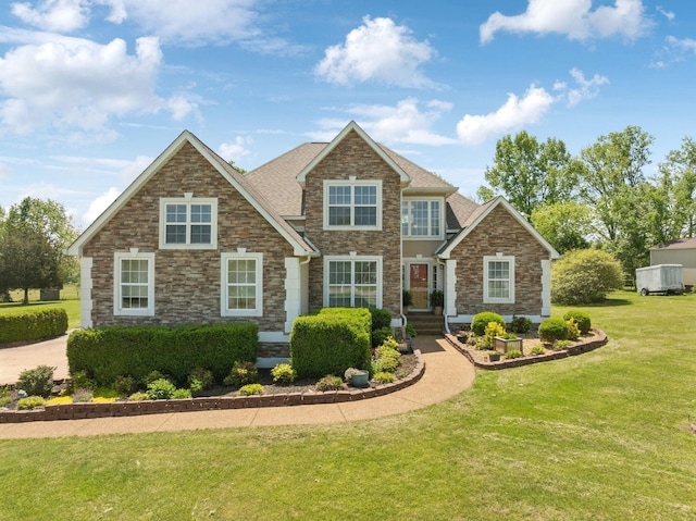 view of front of house featuring a front yard and stone siding