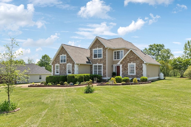 traditional-style house with a front lawn, stucco siding, and stone siding