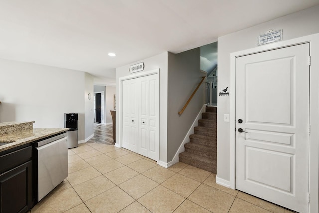 kitchen featuring dishwasher, baseboards, recessed lighting, dark cabinets, and light tile patterned floors