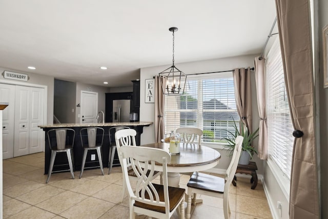 dining space featuring recessed lighting, baseboards, light tile patterned floors, and a chandelier