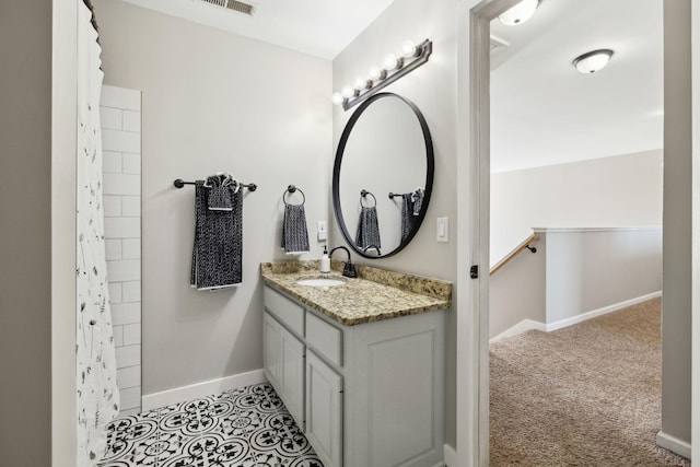 bathroom featuring baseboards, vanity, and visible vents
