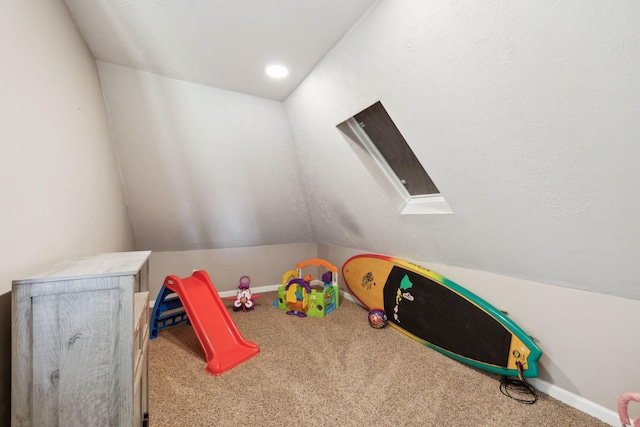 playroom with baseboards, carpet flooring, and lofted ceiling with skylight