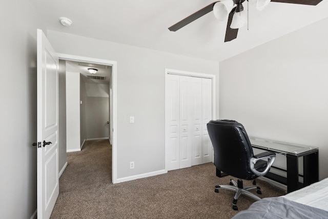 office featuring carpet flooring, ceiling fan, visible vents, and baseboards