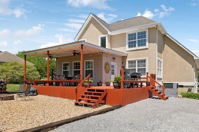 rear view of property featuring a deck, cooling unit, a ceiling fan, and stucco siding