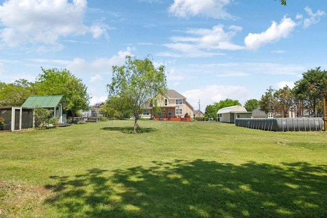 view of yard with an outbuilding and an outdoor pool