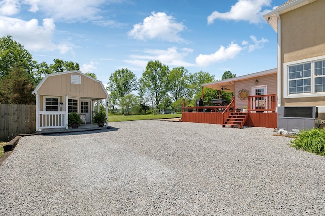 exterior space featuring a wooden deck and fence