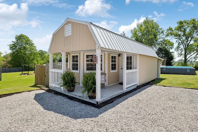view of outbuilding with fence and an outbuilding