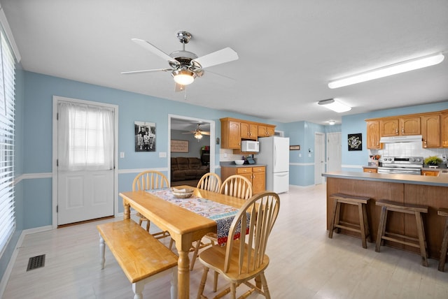 dining area featuring visible vents, light wood finished floors, and ceiling fan