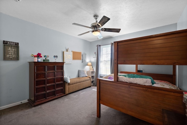 carpeted bedroom featuring baseboards, a ceiling fan, and a textured ceiling