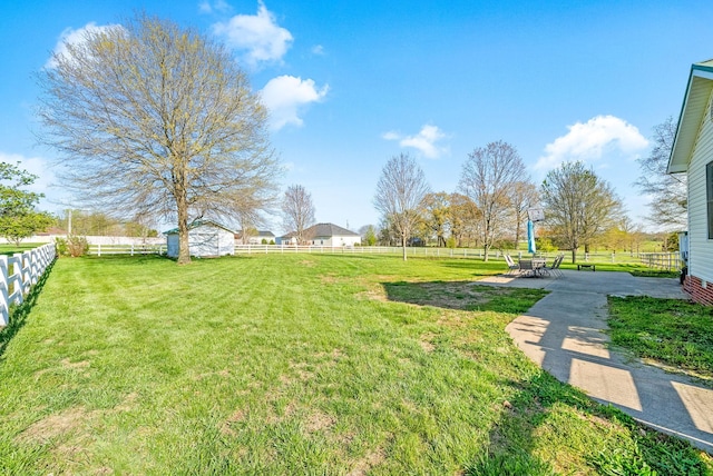 view of yard with an outbuilding, a shed, and a fenced backyard
