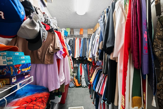 walk in closet featuring carpet flooring